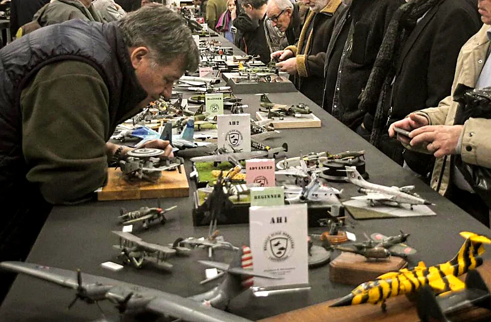Visitors studying models on the contest table