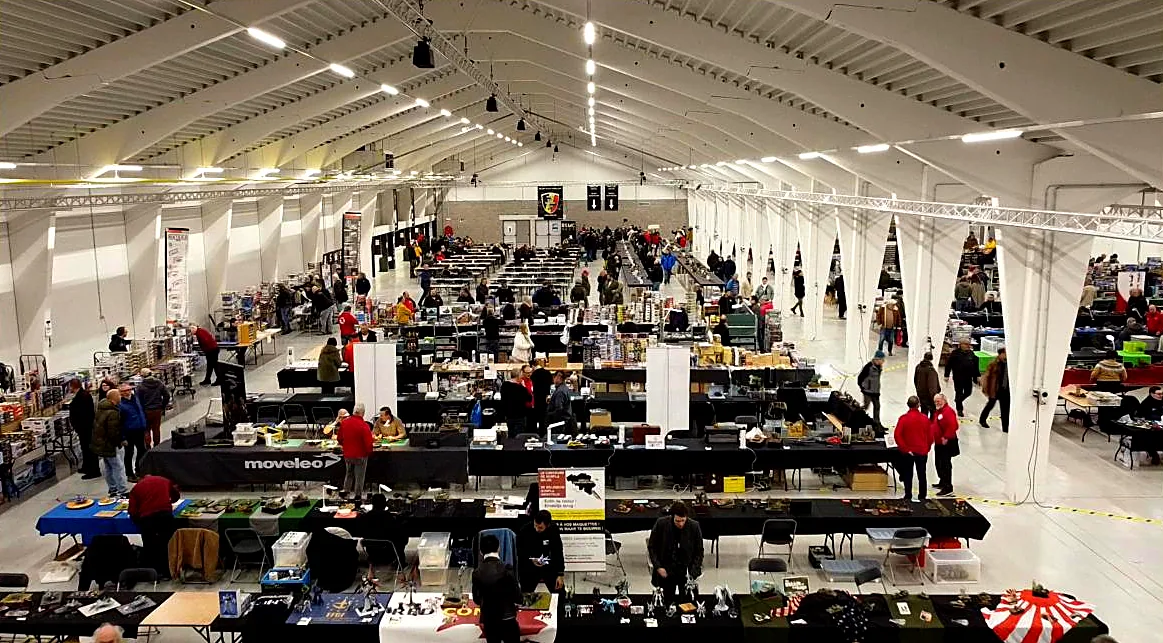 Visitors browsing the trader tables in the exhibition hall